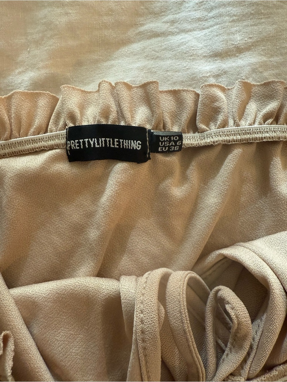 PrettyLittleThing Beige Ruffle Strapless One-Piece Romper - Picture 2 of 3